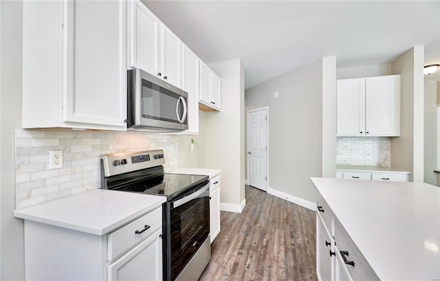 kitchen with backsplash, wood finished floors, light countertops, baseboards, and stainless steel appliances