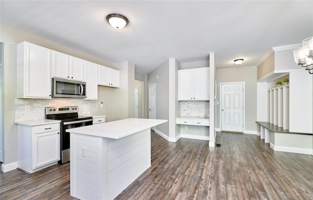 kitchen featuring backsplash, white cabinetry, appliances with stainless steel finishes, and dark wood-style floors