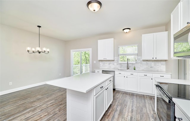 kitchen featuring light wood-type flooring, a sink, appliances with stainless steel finishes, and a healthy amount of sunlight