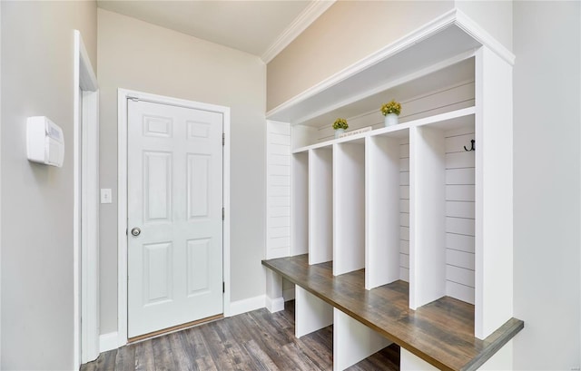 mudroom with crown molding, baseboards, and dark wood-style floors
