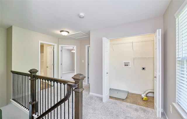 corridor featuring light carpet and an upstairs landing