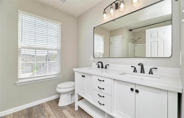 full bathroom featuring a sink, toilet, and a healthy amount of sunlight