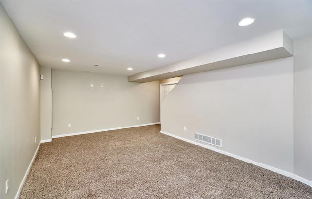 finished below grade area with visible vents, recessed lighting, baseboards, and carpet floors