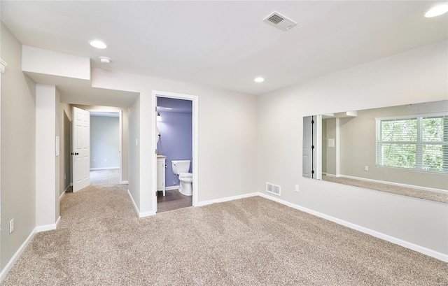 interior space with carpet floors, recessed lighting, baseboards, and visible vents