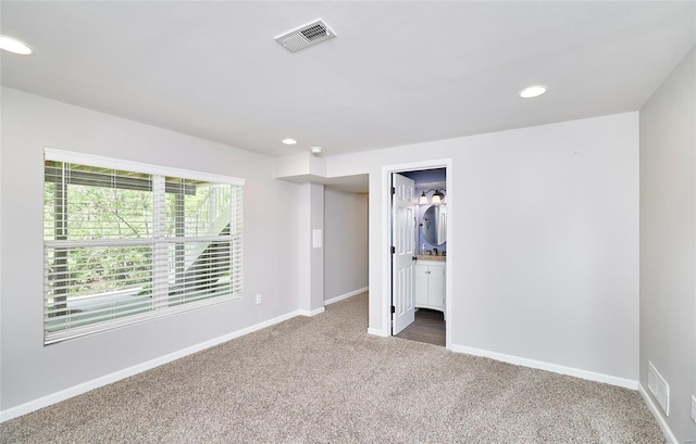 unfurnished bedroom with carpet flooring, recessed lighting, baseboards, and visible vents