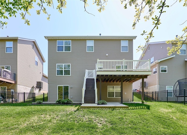 rear view of house with a fenced backyard, a yard, a patio area, and a deck