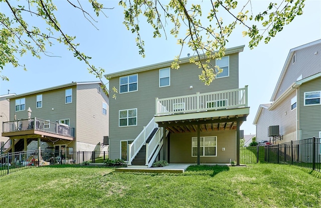 rear view of house with a yard, a deck, stairs, and a fenced backyard