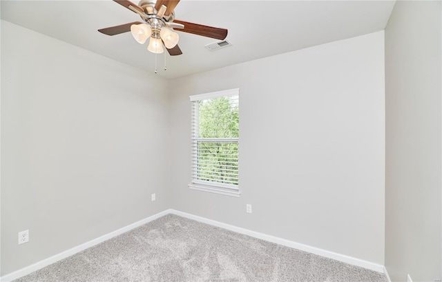 carpeted empty room with a ceiling fan, baseboards, and visible vents