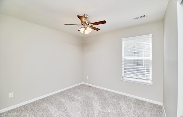 empty room featuring baseboards, a ceiling fan, carpet, and visible vents