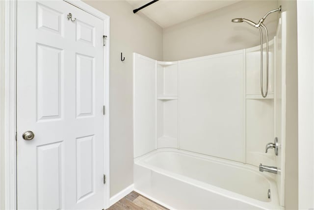 full bath with baseboards, shower / tub combination, and wood finished floors