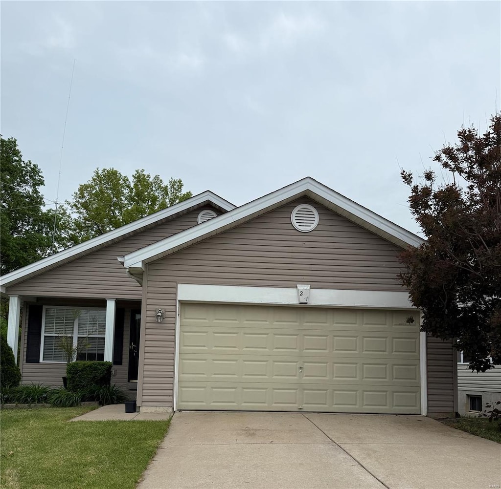 single story home featuring an attached garage and driveway