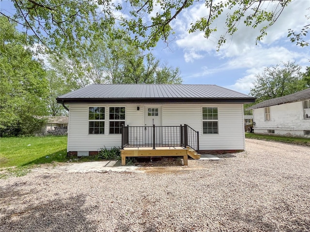 rear view of house featuring metal roof