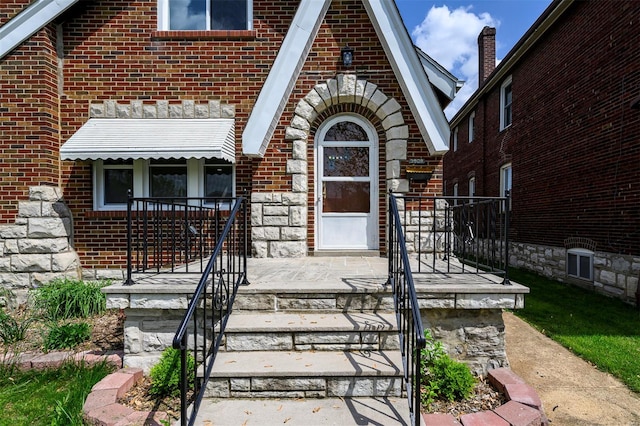 property entrance with brick siding
