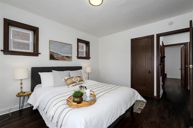 bedroom with baseboards and wood finished floors