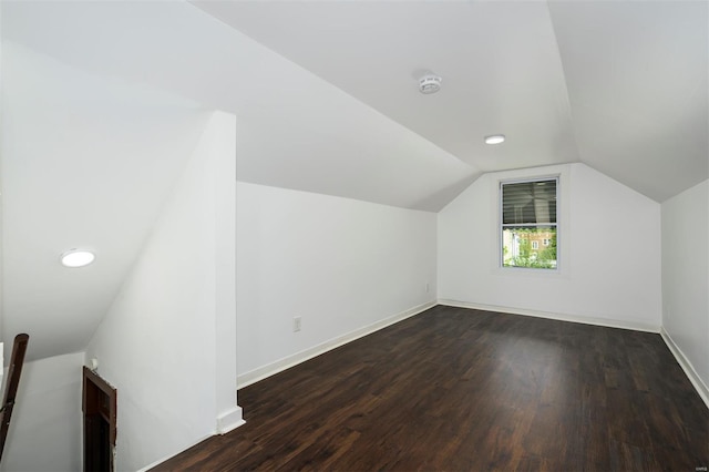 bonus room with baseboards, recessed lighting, lofted ceiling, and dark wood-style floors