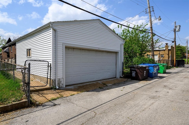 detached garage with fence and a gate