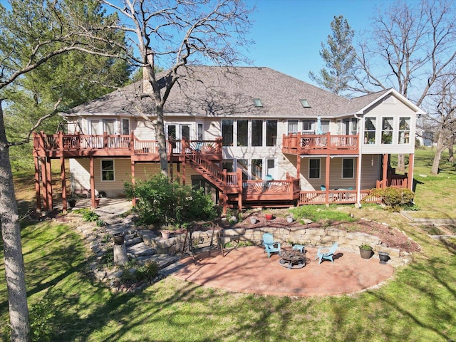 back of property featuring a patio, a fire pit, and a deck