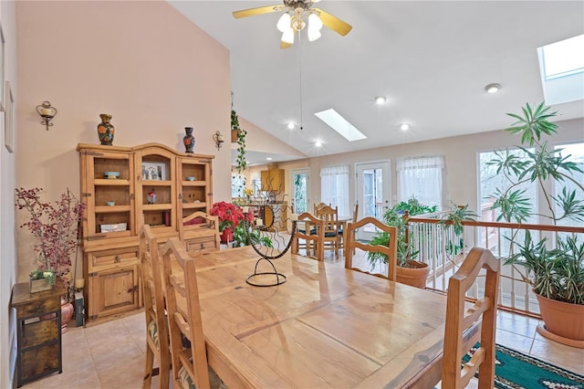 dining space with recessed lighting, a ceiling fan, light tile patterned floors, and a skylight