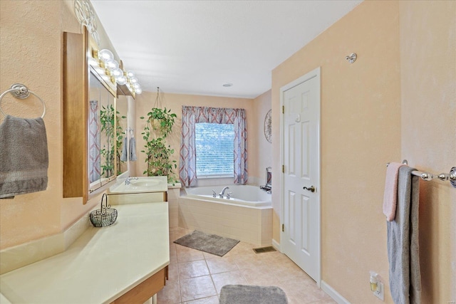bathroom featuring vanity, a garden tub, and tile patterned floors