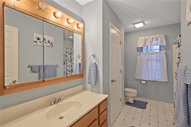 full bath with toilet, baseboards, tile patterned floors, and vanity