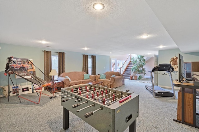 rec room featuring carpet flooring, a textured ceiling, and a wealth of natural light