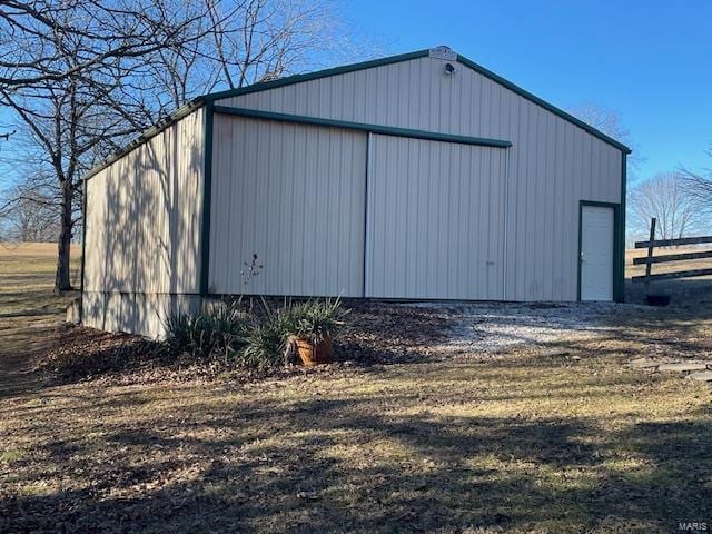 view of pole building with fence