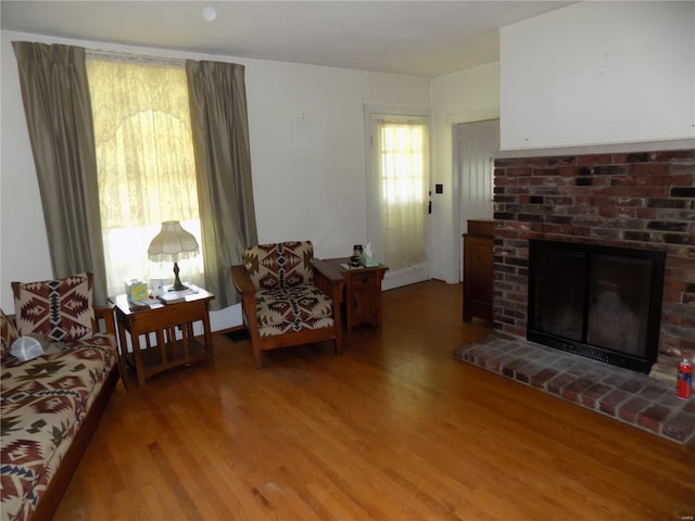 living area with a fireplace and light wood finished floors