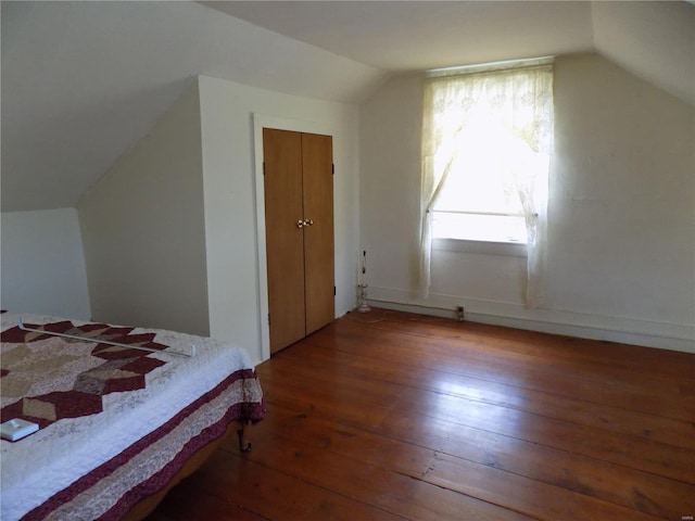 bedroom featuring wood-type flooring and lofted ceiling