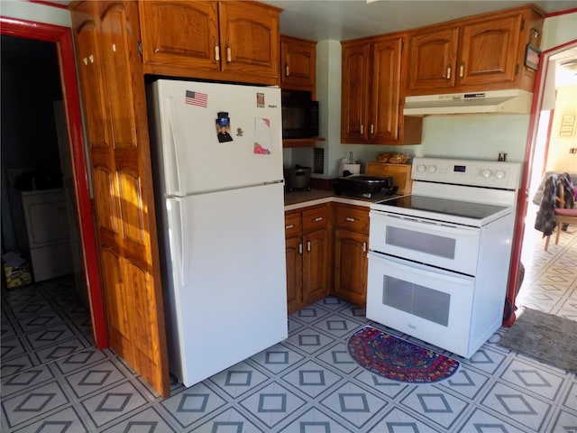 kitchen with white appliances, under cabinet range hood, brown cabinetry, and light countertops