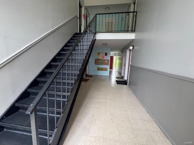 staircase featuring baseboards