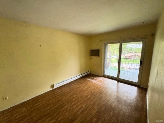 unfurnished room featuring a baseboard radiator and wood finished floors