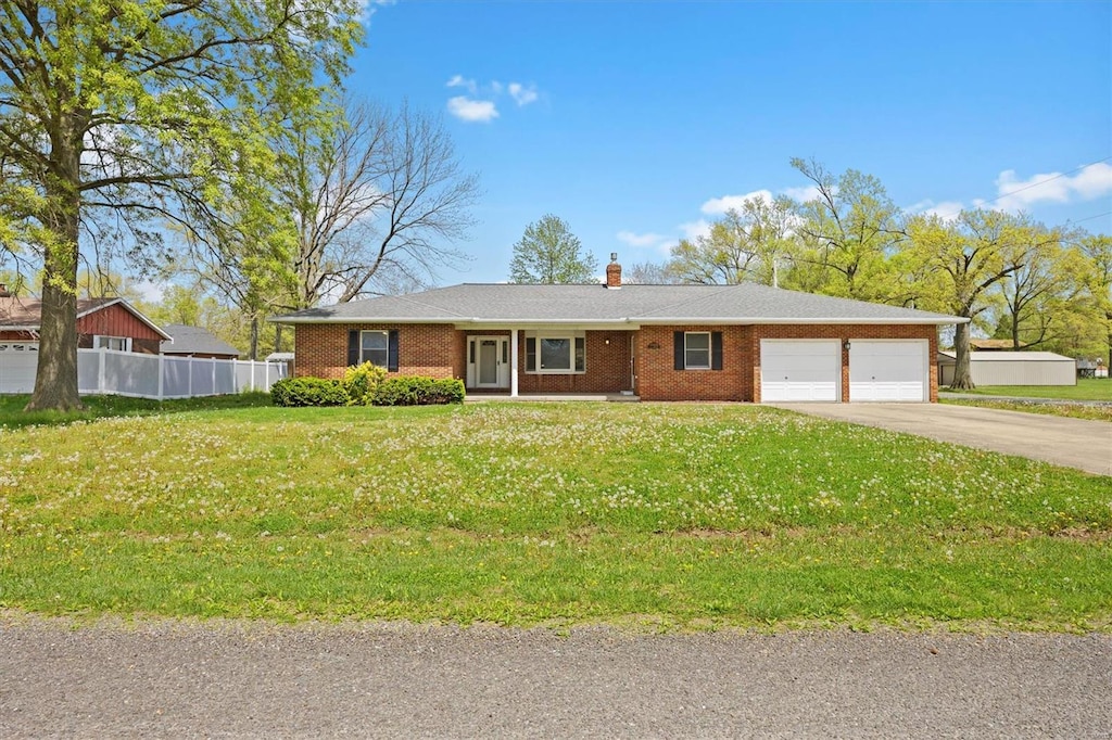ranch-style house featuring driveway, a chimney, brick siding, fence, and an attached garage