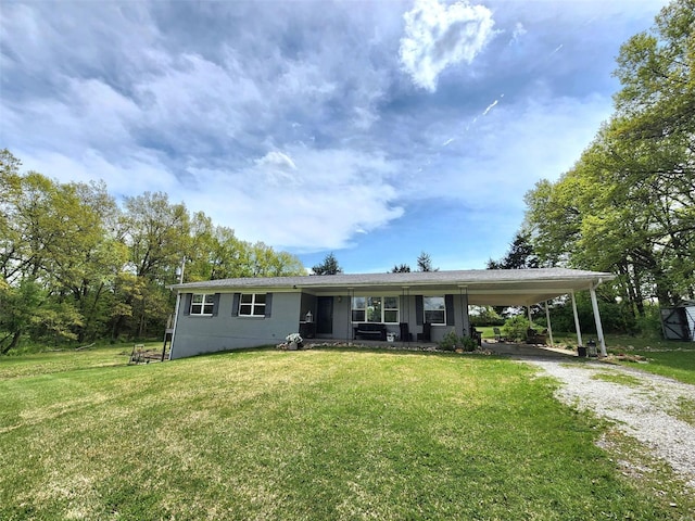 view of front of house with driveway, a front yard, and a carport