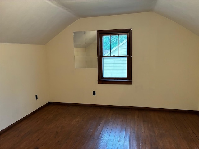 bonus room with baseboards, vaulted ceiling, and dark wood finished floors