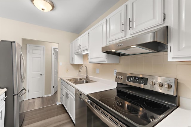 kitchen featuring white cabinetry, under cabinet range hood, and stainless steel appliances