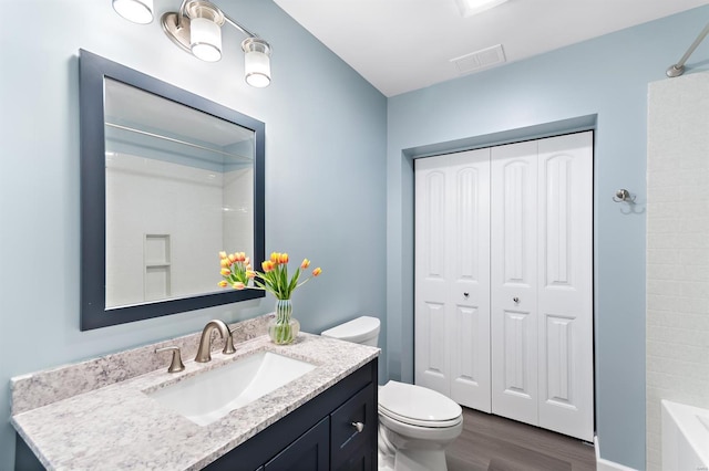 full bath featuring visible vents, wood finished floors, toilet, and vanity