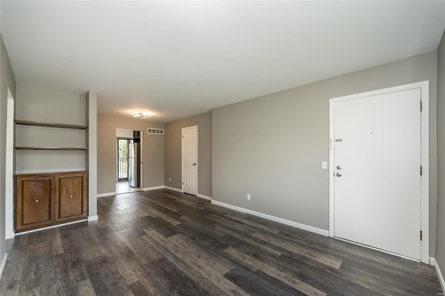unfurnished living room featuring visible vents, dark wood-style flooring, and baseboards