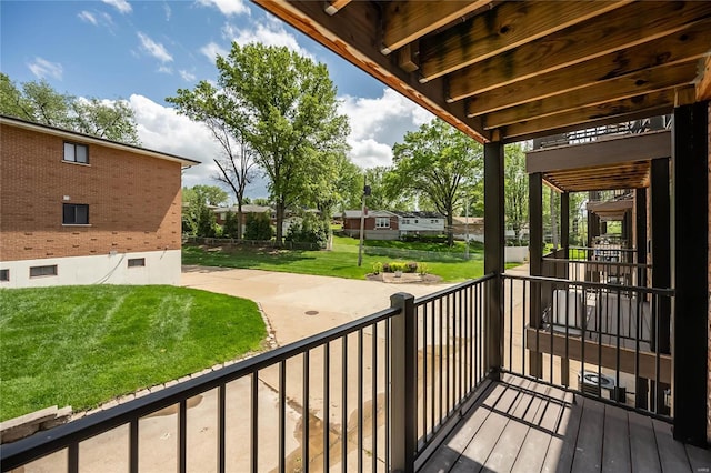 wooden terrace featuring a yard