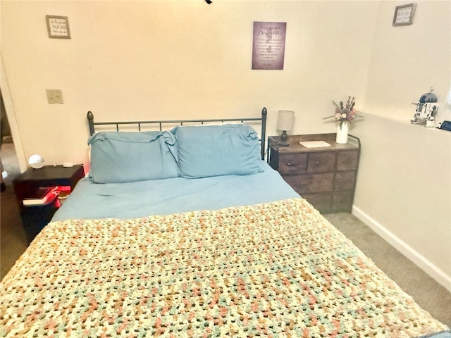 bedroom featuring carpet floors and baseboards