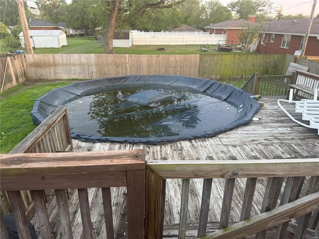 view of swimming pool with a fenced backyard and a wooden deck