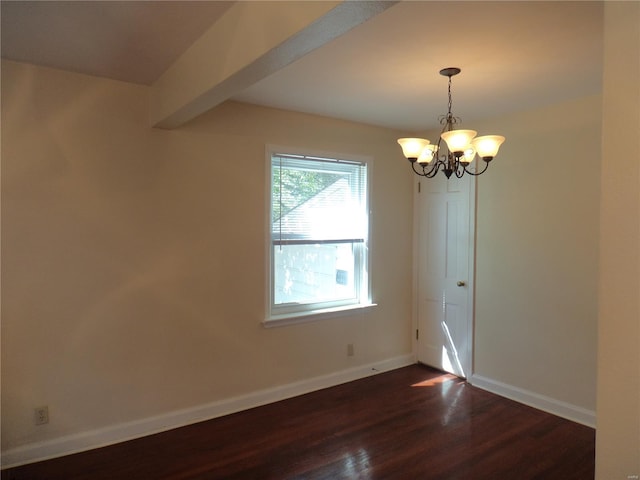 spare room featuring baseboards, an inviting chandelier, and dark wood-type flooring