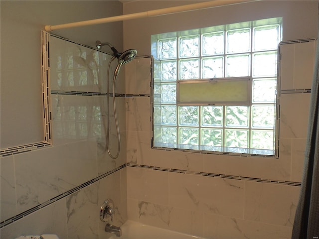 full bath featuring shower / bath combination and a wealth of natural light
