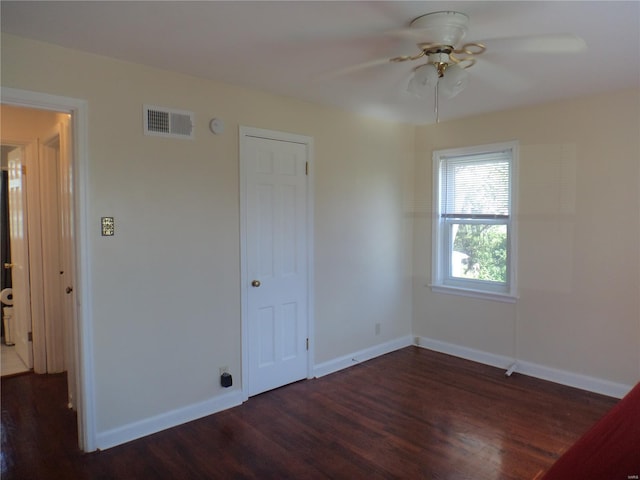 empty room with visible vents, baseboards, ceiling fan, and wood finished floors