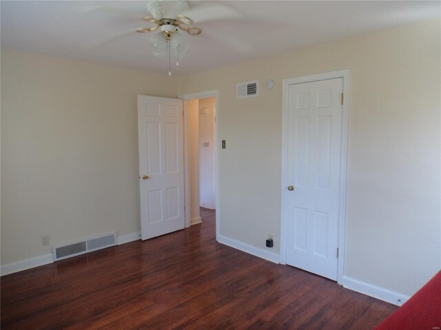 unfurnished bedroom featuring visible vents, a ceiling fan, baseboards, and wood finished floors