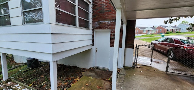 exterior details featuring central AC, a gate, and fence