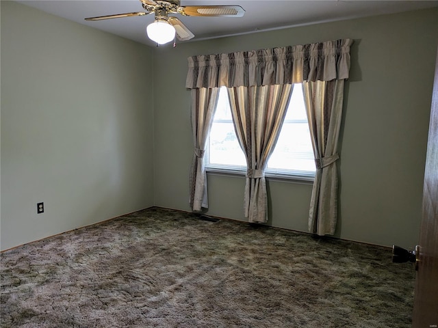 empty room featuring carpet floors and ceiling fan