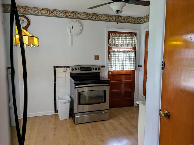 kitchen featuring electric range, light wood finished floors, and ceiling fan
