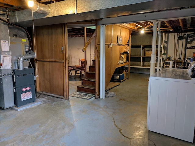 unfinished below grade area featuring washer and dryer and stairway