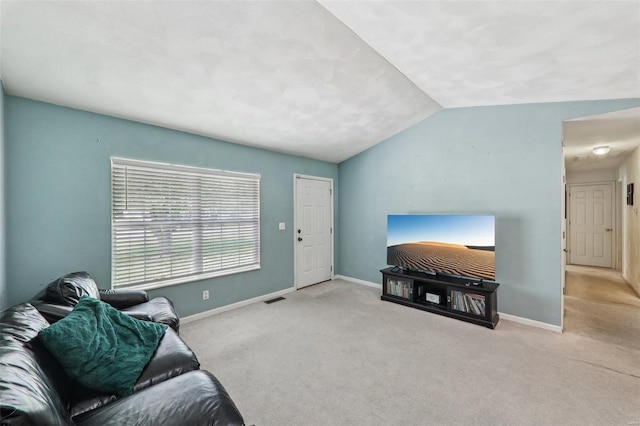 living room featuring baseboards, carpet, lofted ceiling, and visible vents
