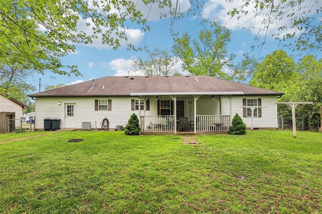 rear view of house with a patio, fence, a yard, and crawl space